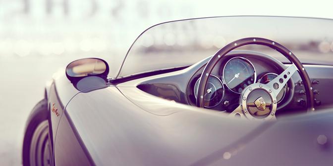 A close-up of a car's interior, specifically the steering wheel and dashboard.