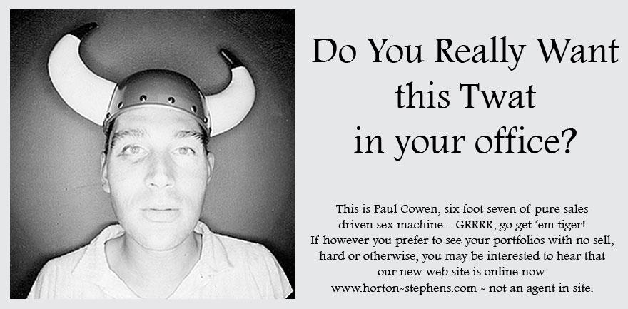 A man wearing a Viking helmet with horns, a white shirt, and a serious expression.