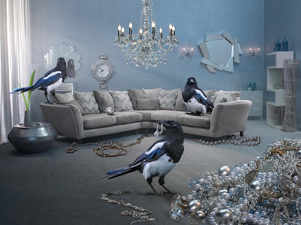 A room filled with a large amount of jewelry and a few magpies, one of which is holding a necklace.