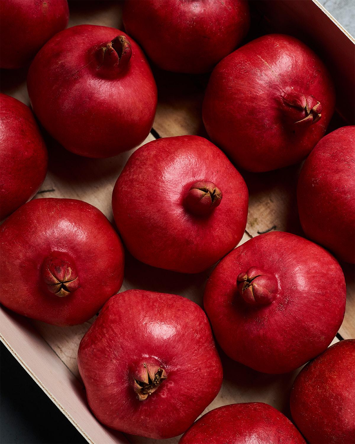 A box of pomegranates, a type of fruit.