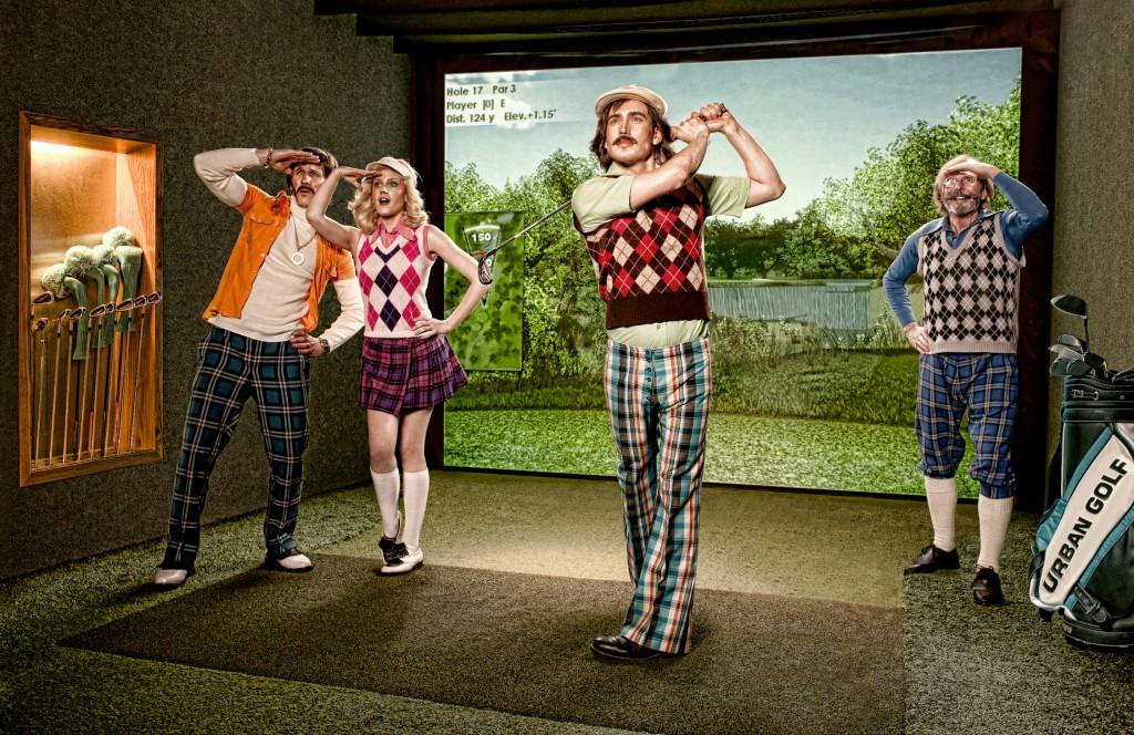 Four golfers, two men and two women, dressed in golfing attire, including golf shirts, golf pants, golf shoes, and golf hats, standing in a golfing environment.