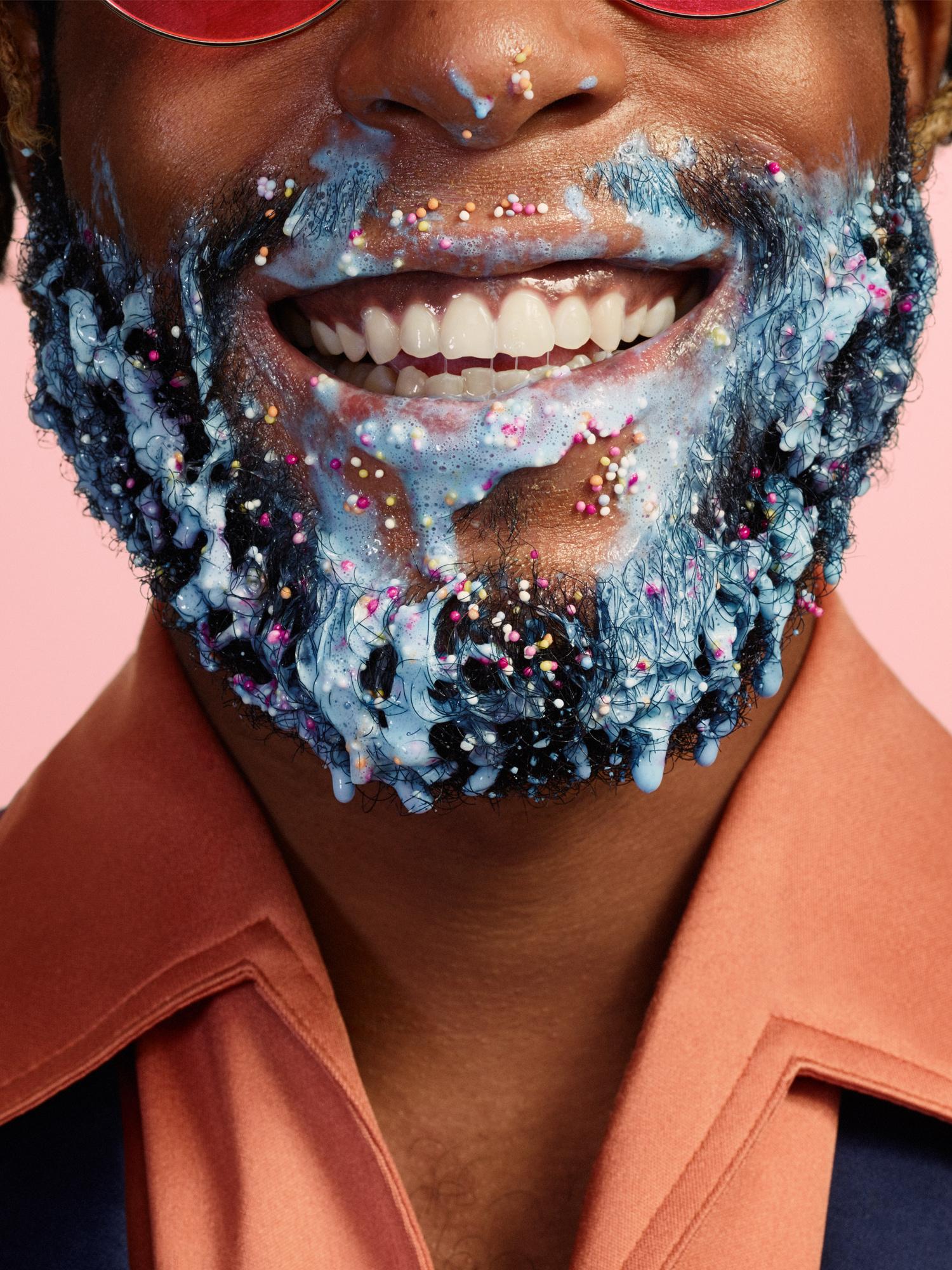A man with a beard covered in a sweet-tasting food substance.