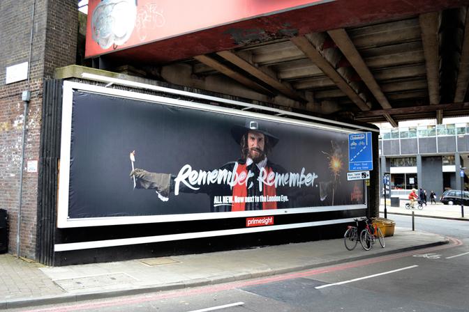 A large billboard featuring a man in a 17th-century style costume, with a city street in the background.