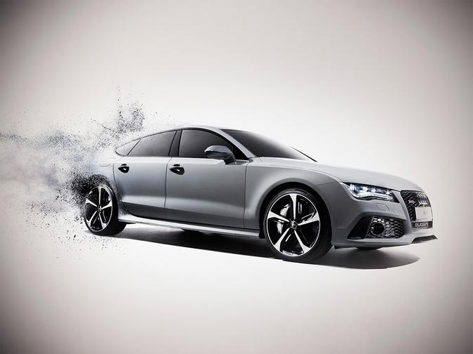 A silver Audi car is exploding in a cloud of smoke and debris.