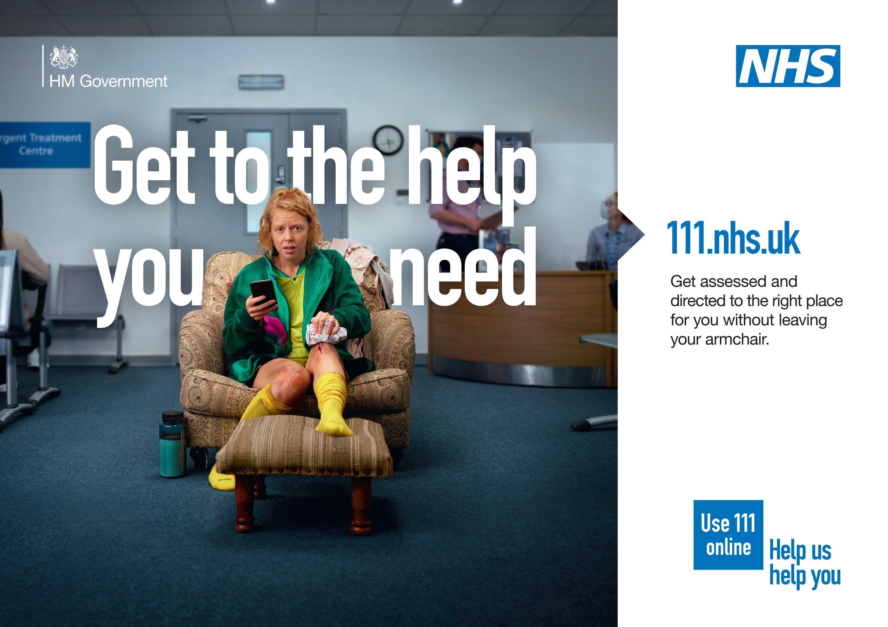 A woman in a hospital waiting room, wearing a green hospital gown, yellow socks, and a green robe, sitting in a chair, holding a phone and looking concerned.