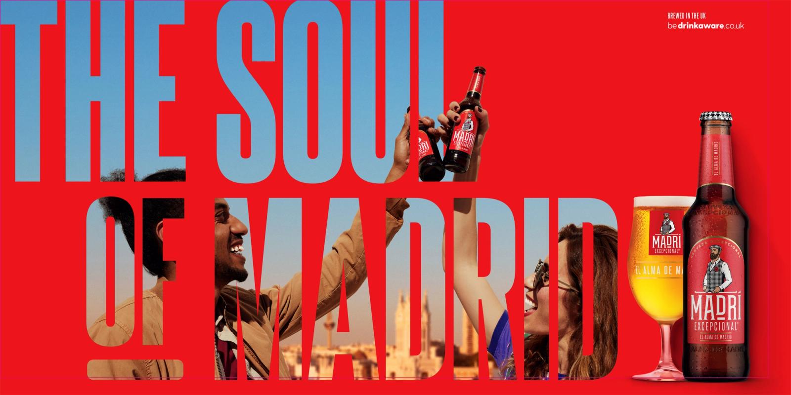 A red background with large light blue text saying 'THE SOU OF MAD', a man in a tan jacket and red scarf, and a beer bottle and glass in the foreground.