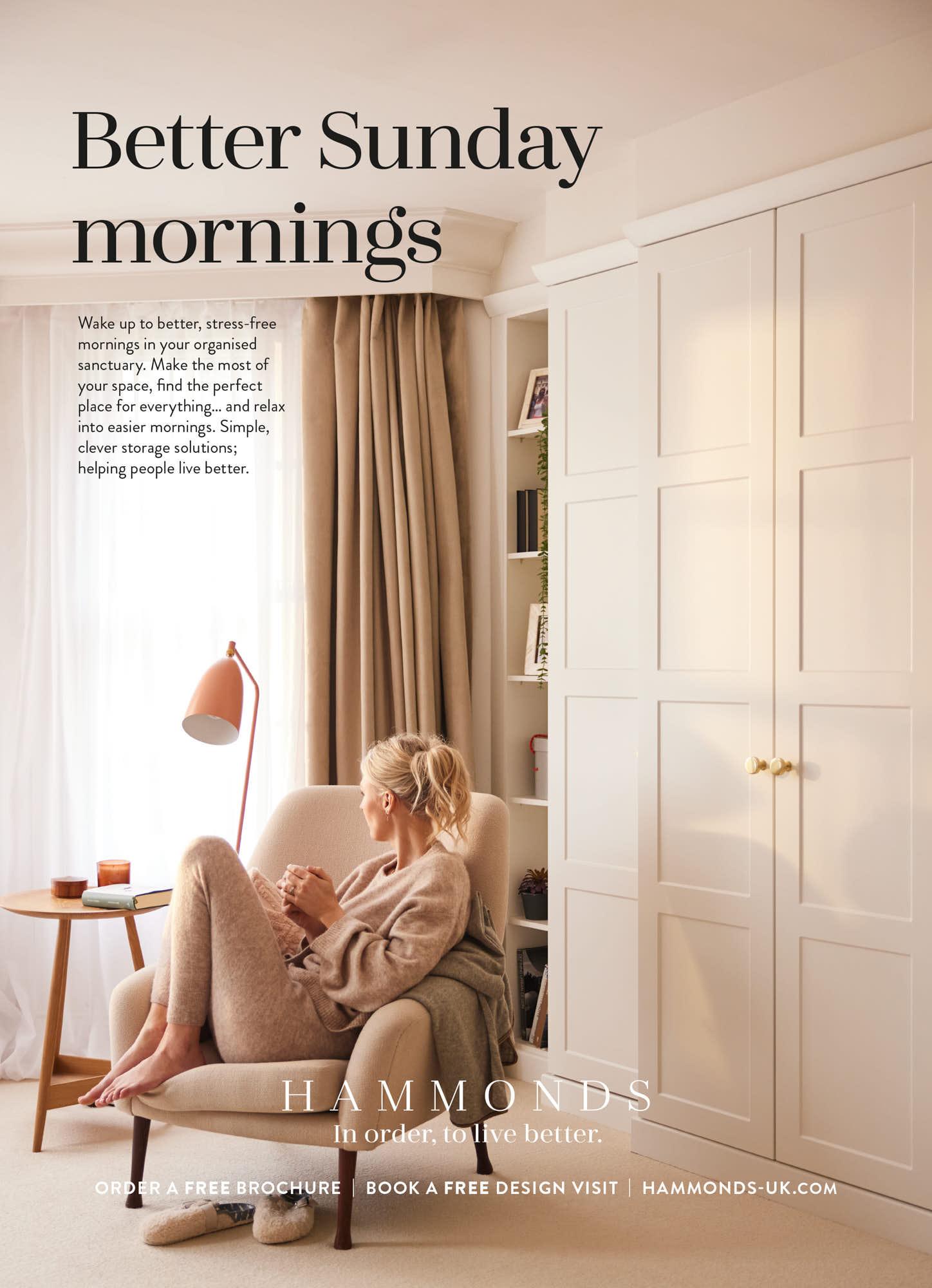 A woman sits in a beige chair, holding a mug and gazing out the window, enjoying her Sunday morning. She's surrounded by soft, natural light, creating a peaceful atmosphere.