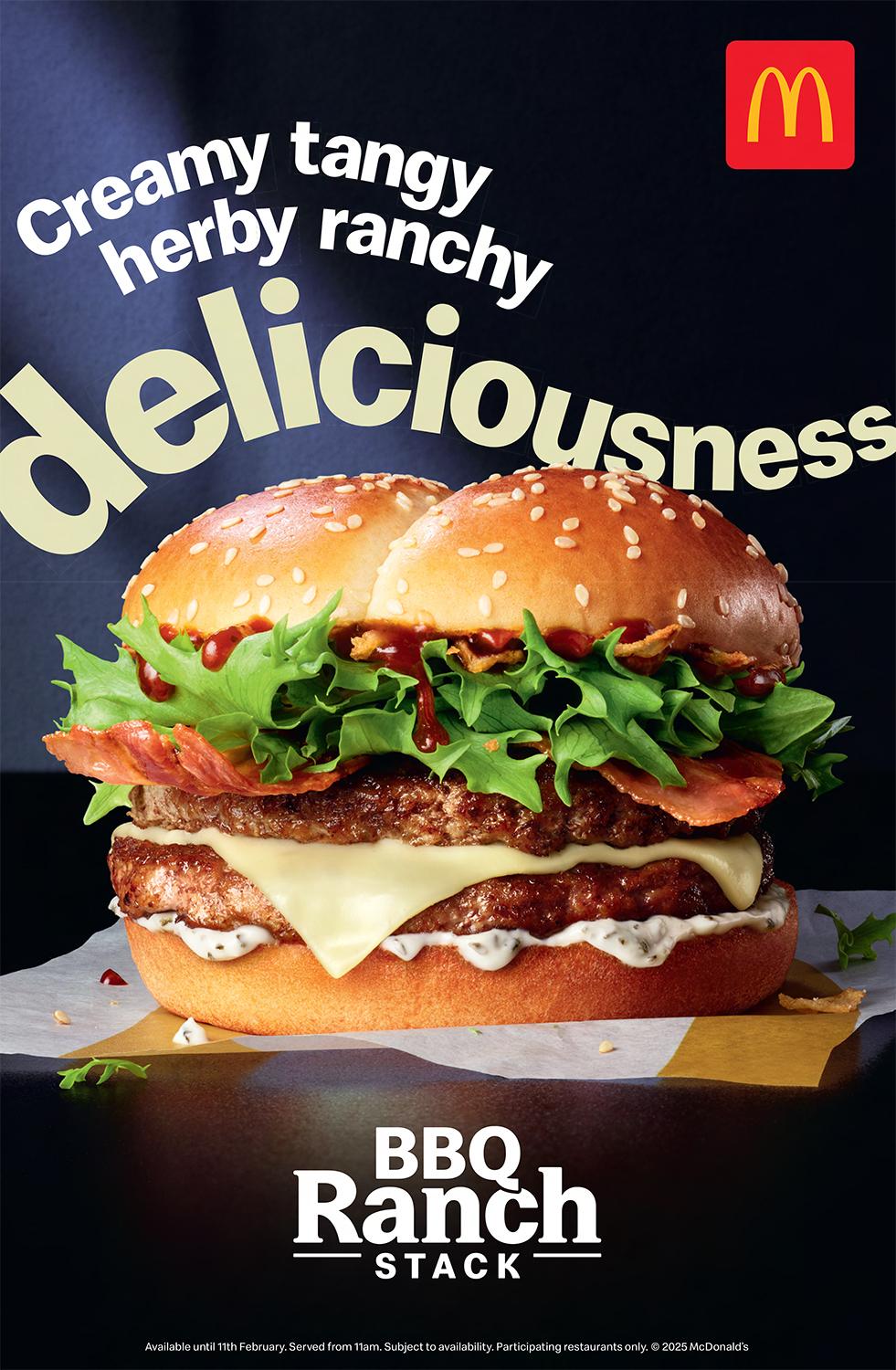 A large, juicy burger with a beef patty, cheese, lettuce, tomato, and a sesame seed bun, sitting on a paper wrapper with a red and yellow McDonald's logo in the top left corner.