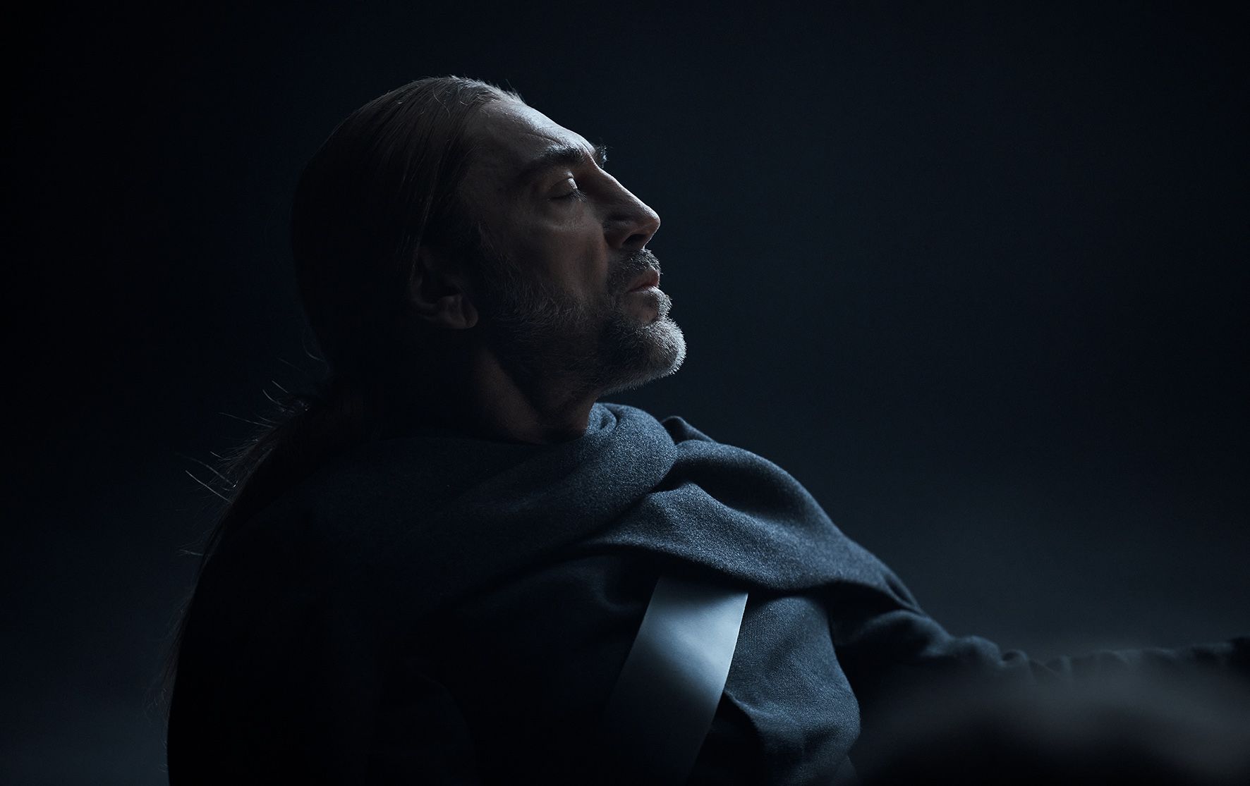 Javier Bardem looks up and to the right with a serious expression in an Uber Eats-themed artwork.