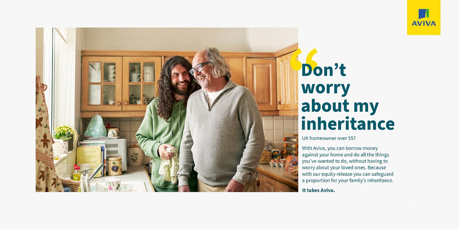 Two men in a kitchen, one with long hair and a beard, the other with a balding head and glasses, both smiling and holding a kitchen utensil.