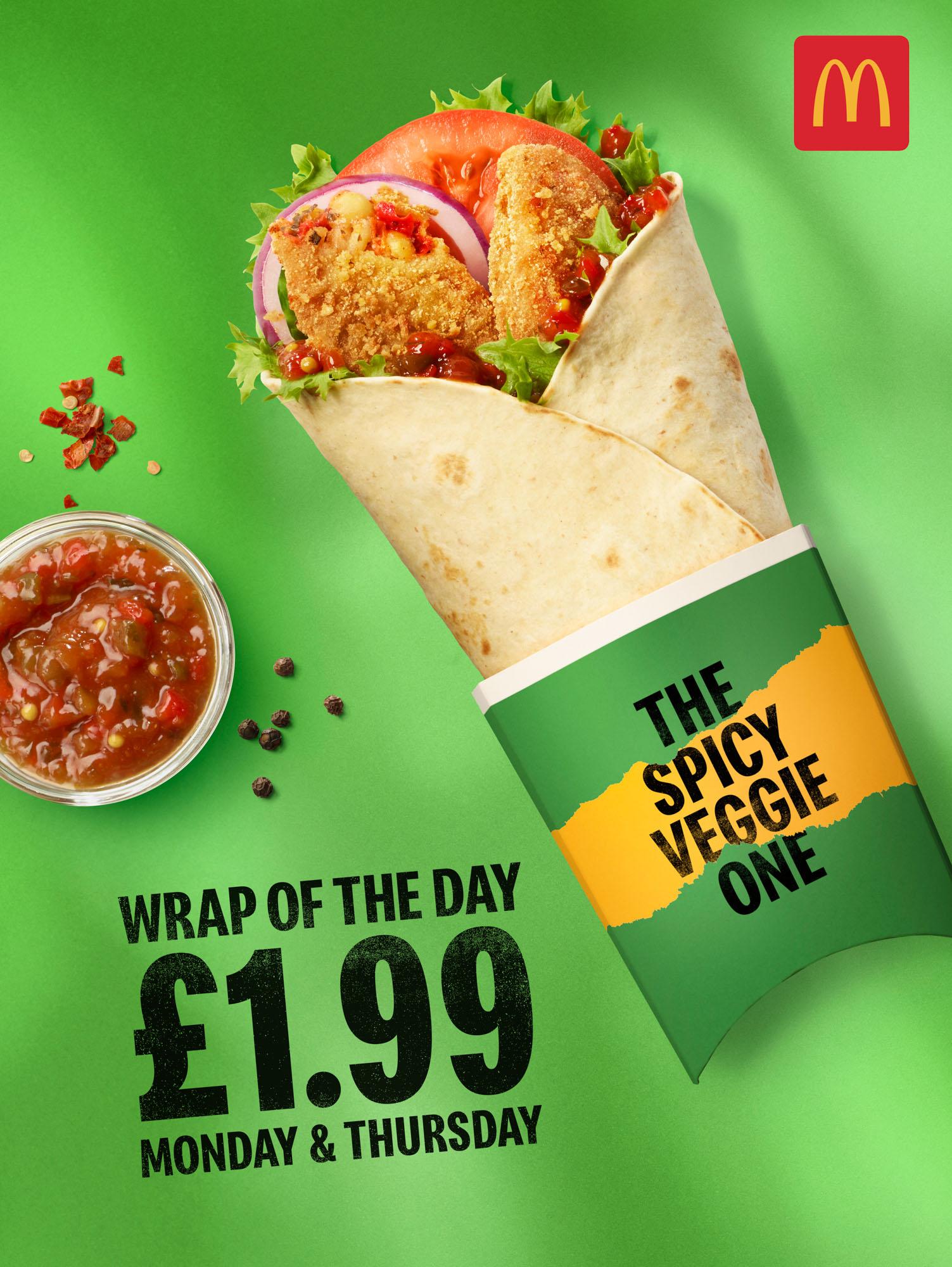 A McDonald's ad showing a chicken wrap with spicy sauce, lettuce, tomato, and red onion in a green and yellow wrapper with the McDonald's logo.
