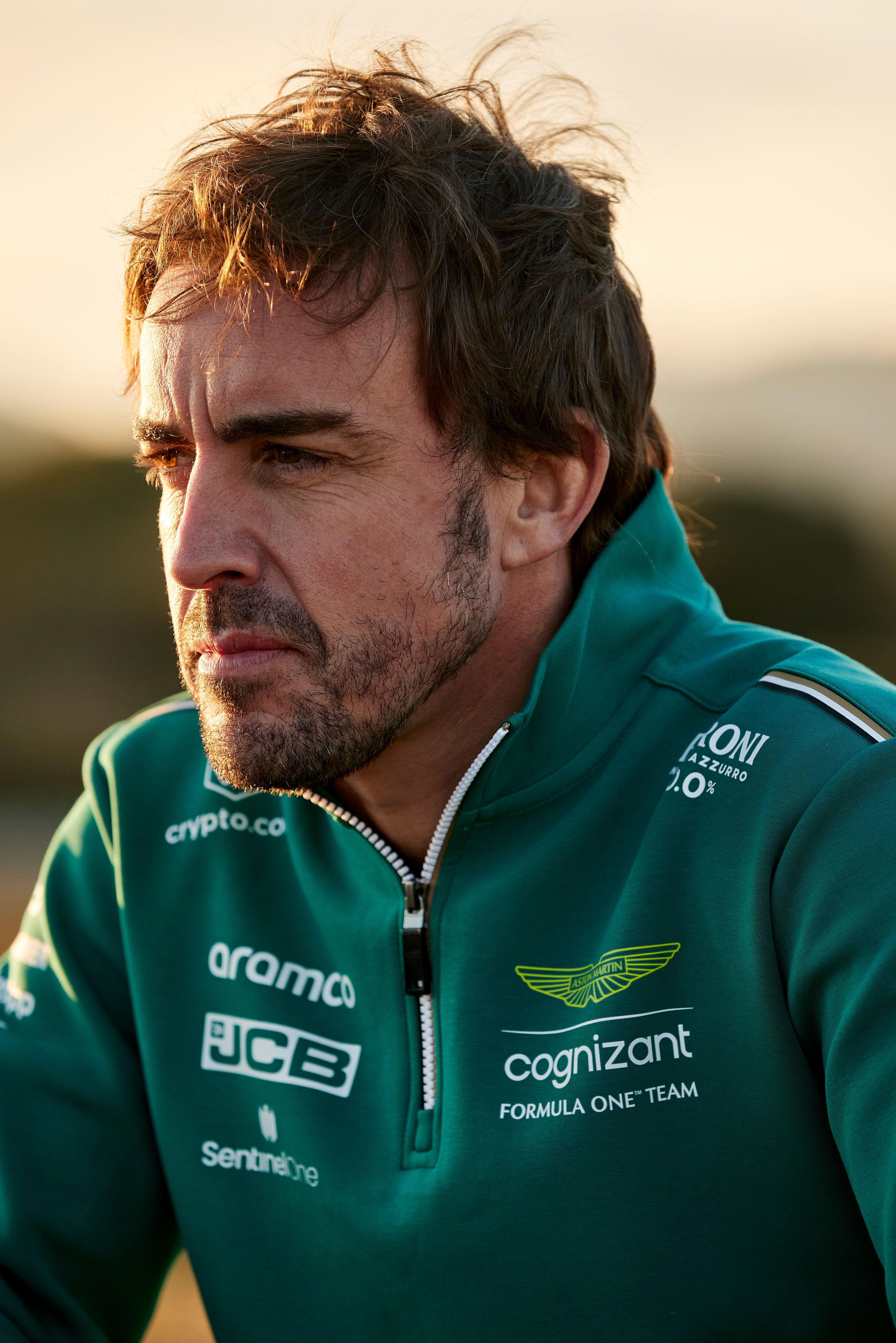 Artist wearing a green jacket with sponsor logos.