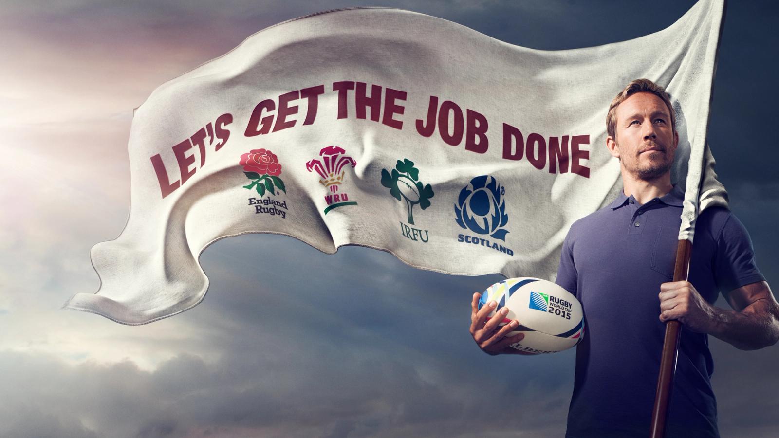 A man holding a rugby ball and a flag with a list of UK rugby teams, including England, Wales, Scotland, and Ireland, with a background of a cloudy sky.