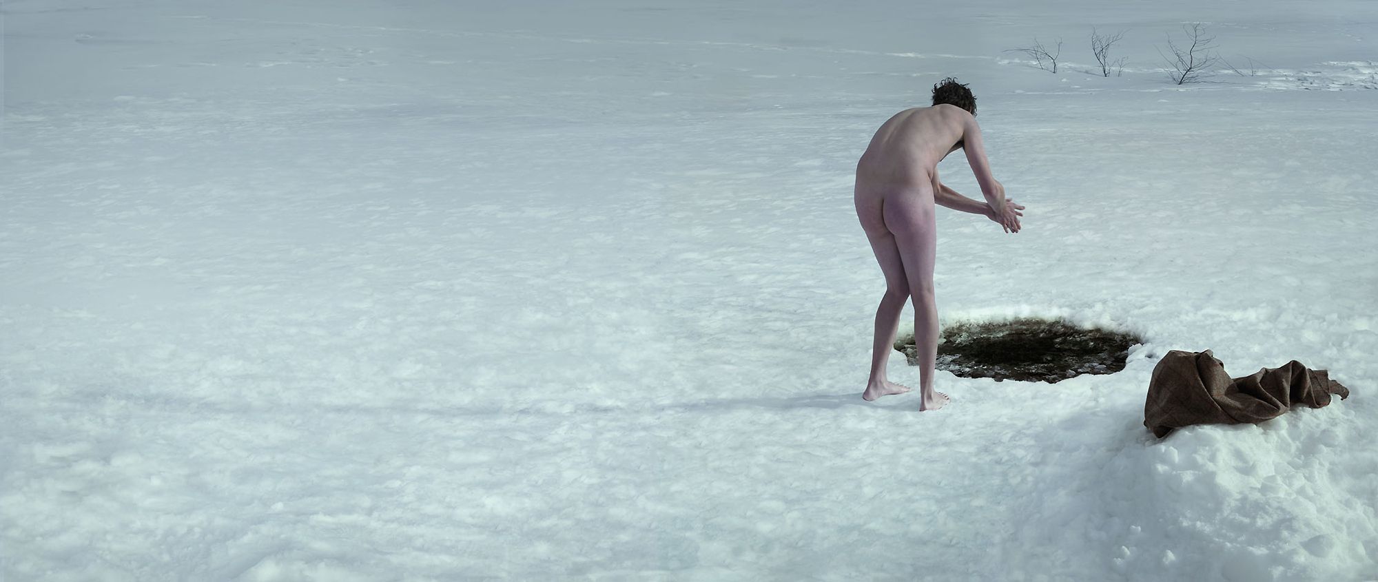 Julian Wolkenstein beechams man about to jump into icy water hole in snow naked