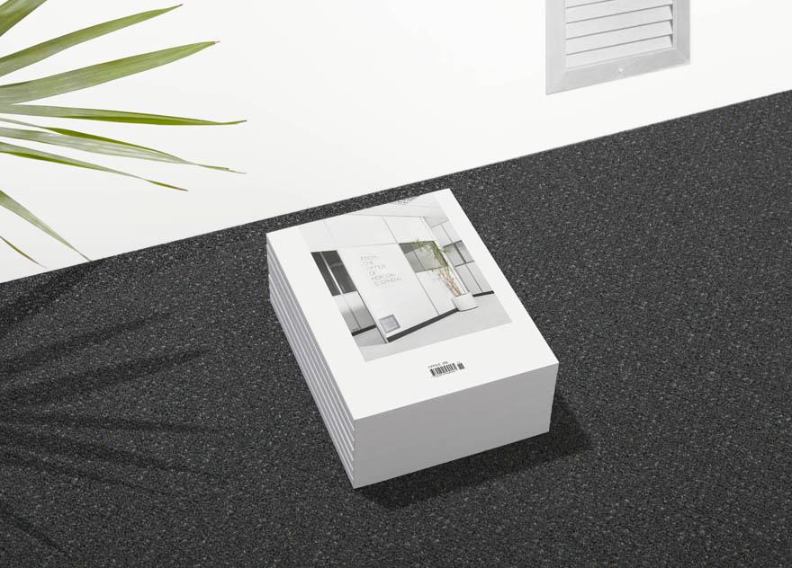 A stack of books with a cover featuring a modern office interior, likely a design or architecture book.