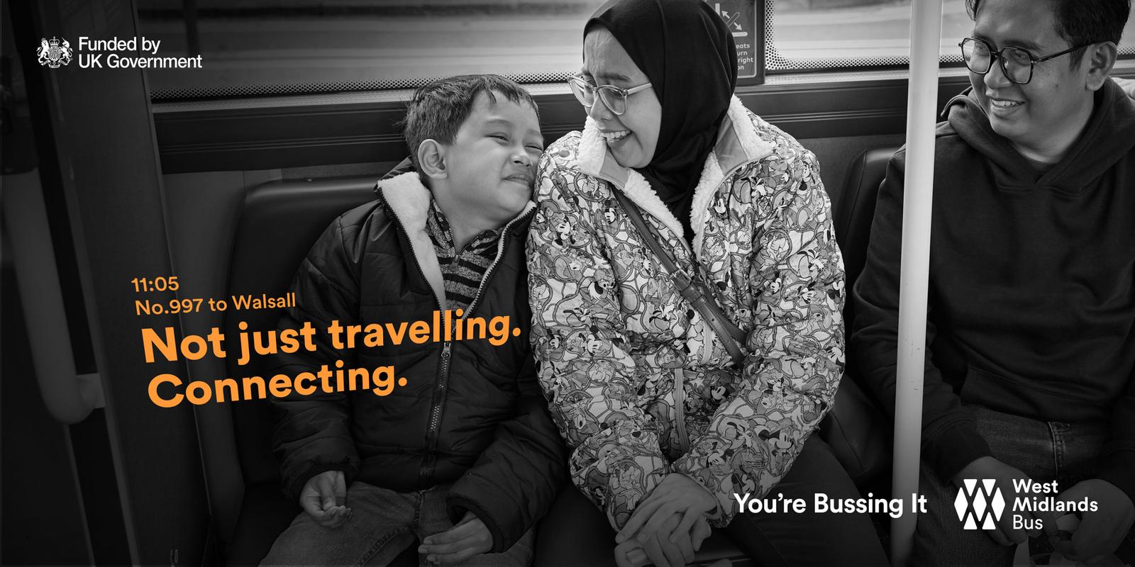 A young boy is sleeping on a bus, surrounded by a woman in a hijab and a man in a dark jacket, with a bus window and a bus seat in the background.