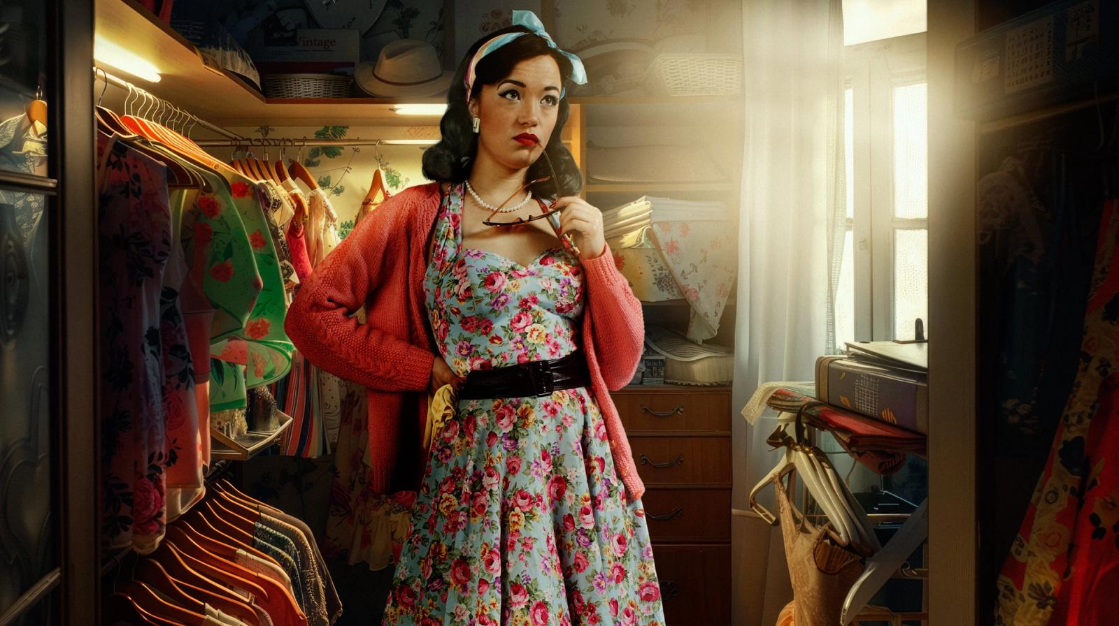 A woman stands in a cluttered closet surrounded by dresses, shoes, and fashion items. Gary Salter — AI Experiment