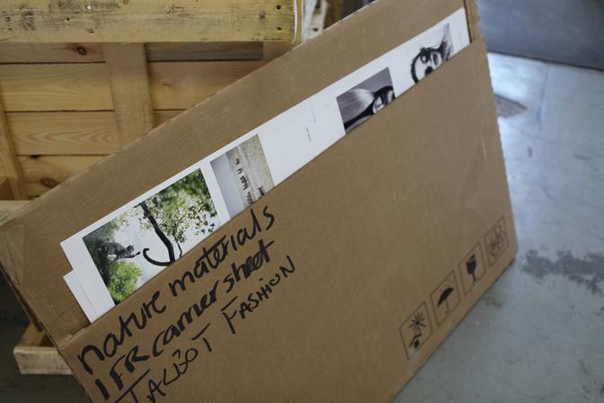 A cardboard box with a label that says 'image specialist' and a few images of nature and art