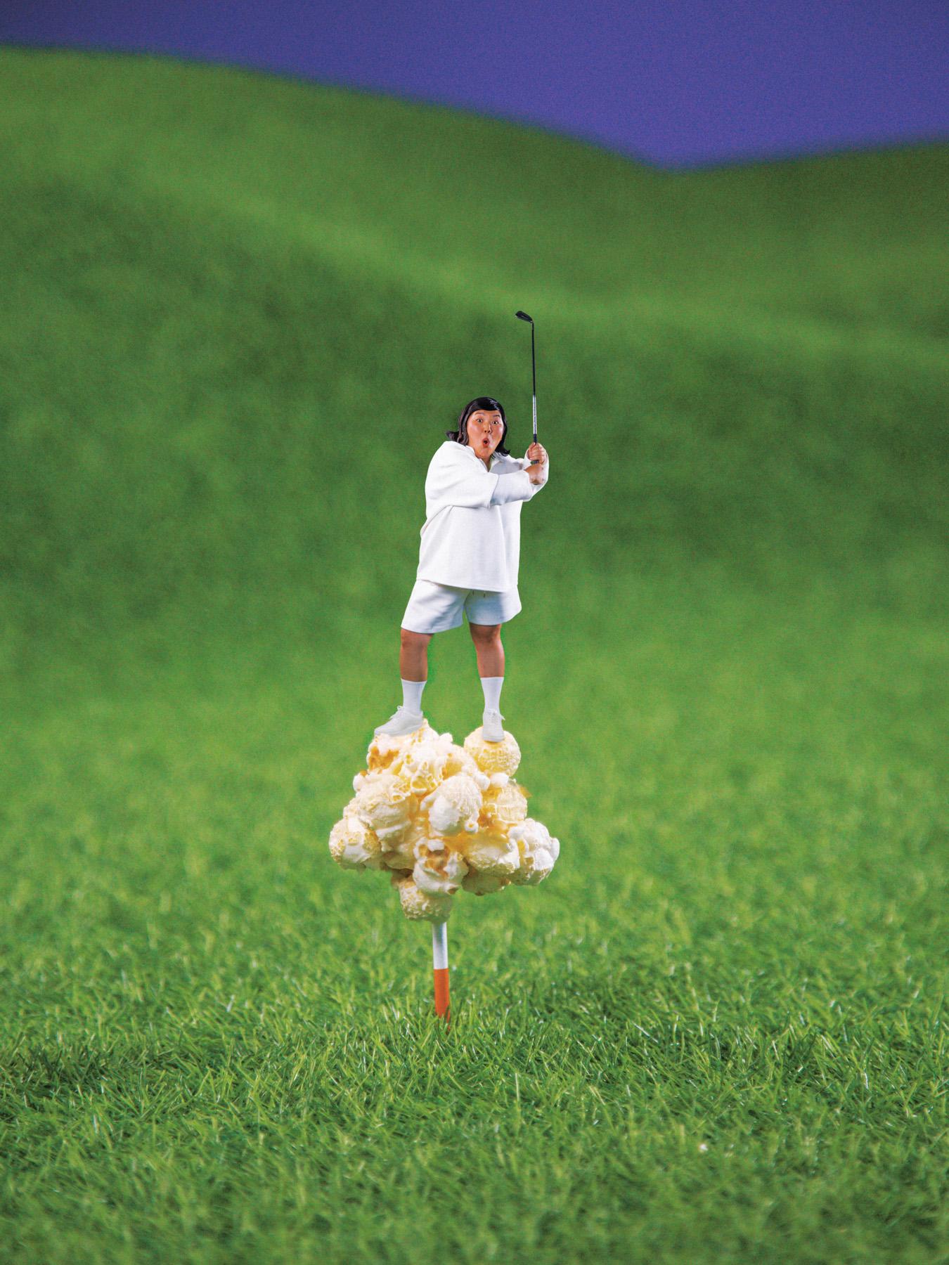 A woman in a white shirt and shorts, standing on a cloud of popcorn, holding a golf club and looking at the camera with a surprised expression.