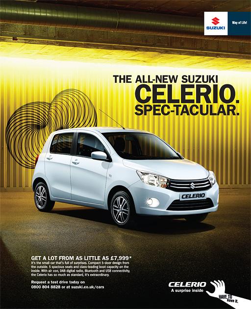 A white Suzuki car is parked in a dimly lit, industrial-style garage with a bright yellow background.