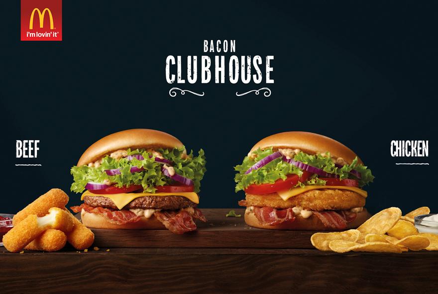 A McDonald's advertisement featuring two burgers, a burger with a beef patty, a burger with a chicken patty, and various side items.