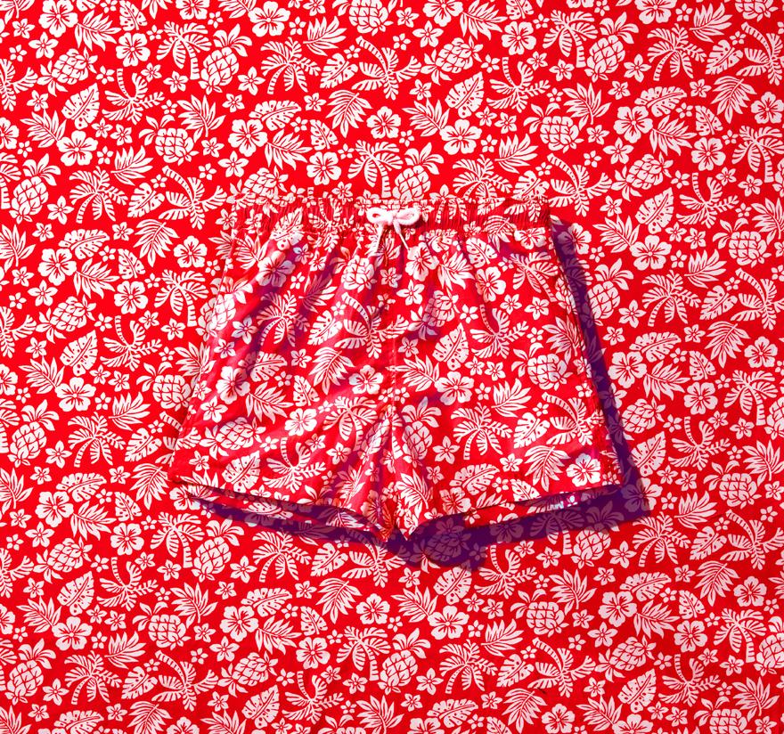 A pair of red and white floral patterned shorts.