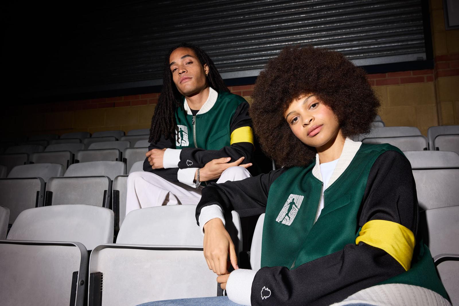 Two individuals sit in a dimly lit auditorium, both wearing green and black jackets with white and yellow accents, for a Snapchat campaign.