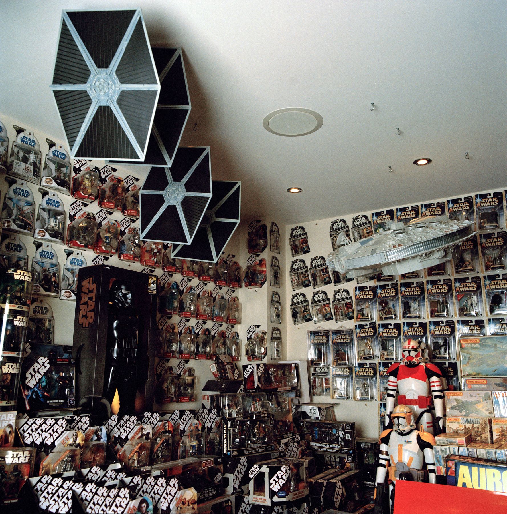 A room displaying various Star Wars merchandise like action figures and masks.