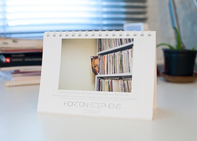 A calendar page featuring a photograph of a woman's face in a book store, surrounded by books and bookshelves.