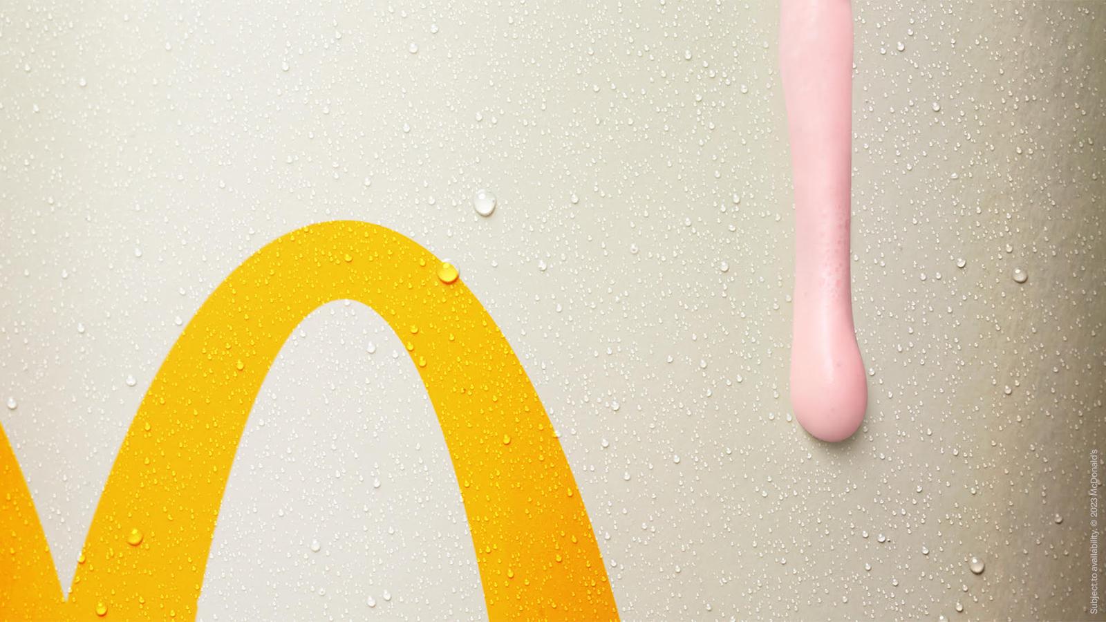 A McDonald's Drips and Spritz campaign image featuring a yellow McDonald's arches logo with a pink and yellow liquid dripping down the right side.
