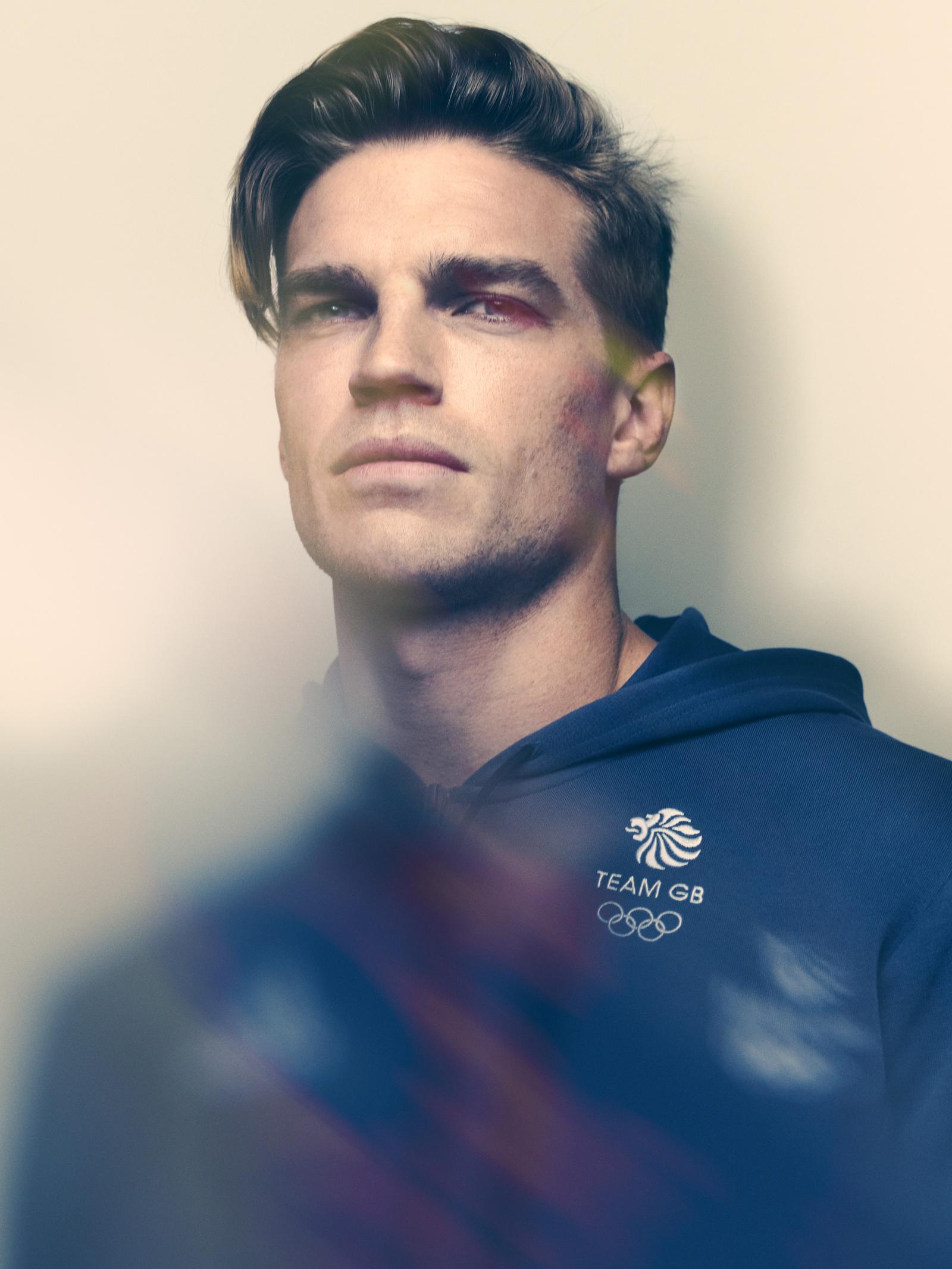 A man with short, dark hair and a serious expression, wearing a Team GB hoodie.