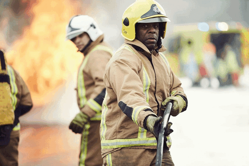 firefights tackling flames epic dramatic smouldering car smiling and serious