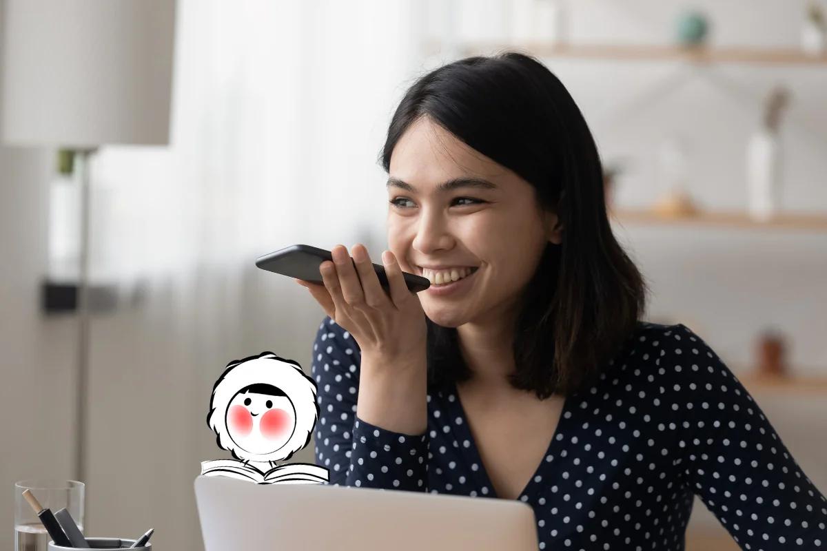 A woman smiling while recording her voice on a smartphone, illustrating how users can customize Waze navigation voices.