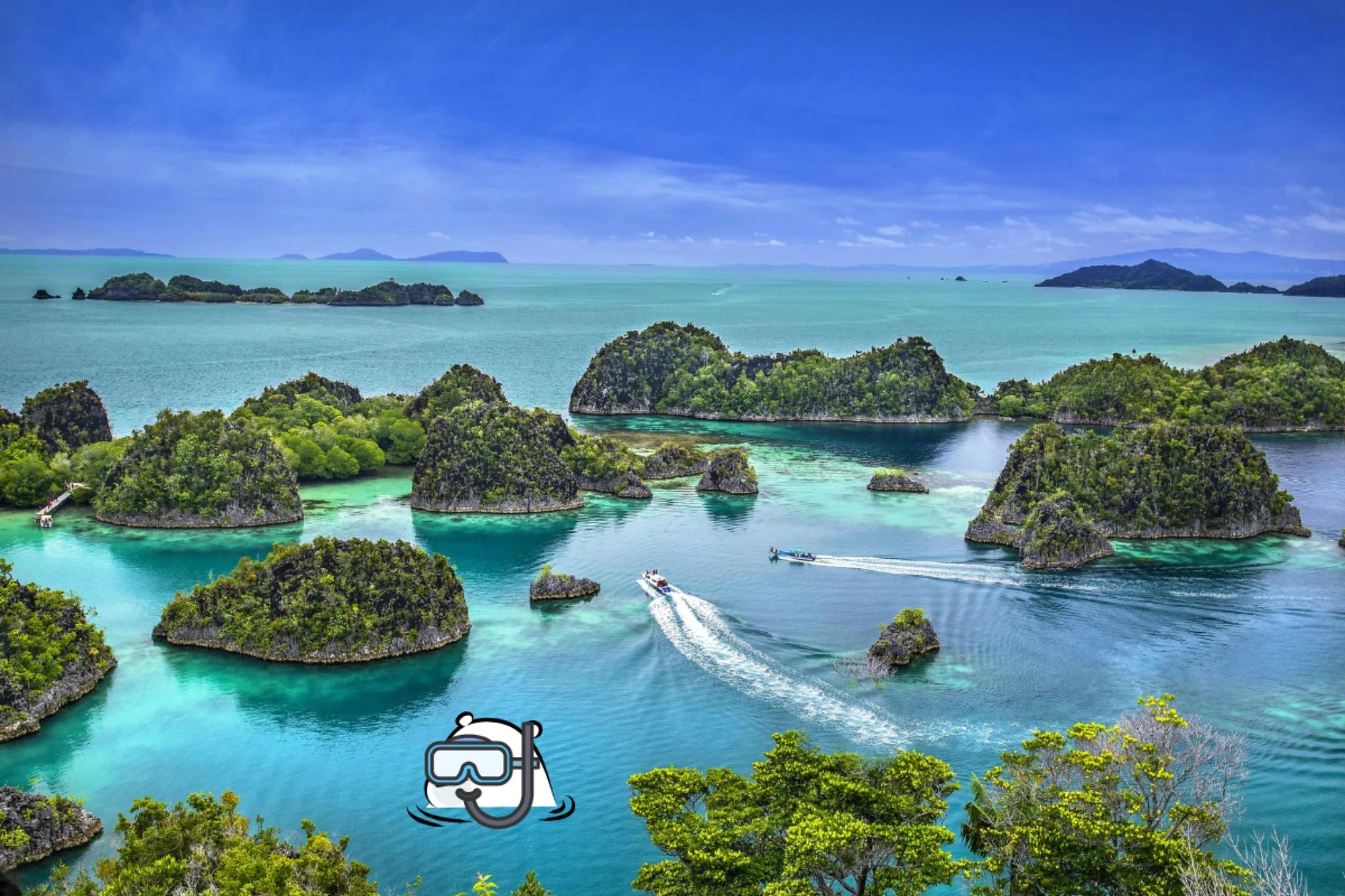 Aerial view of Raja Ampat islands in Indonesia with turquoise lagoons, limestone islets covered in lush greenery, and small boats creating white wakes across the clear blue water.