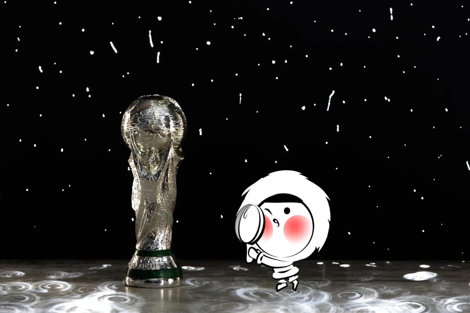 FIFA World Cup trophy standing on a reflective surface under dramatic lighting, with a dark background filled with scattered white light particles resembling stars.