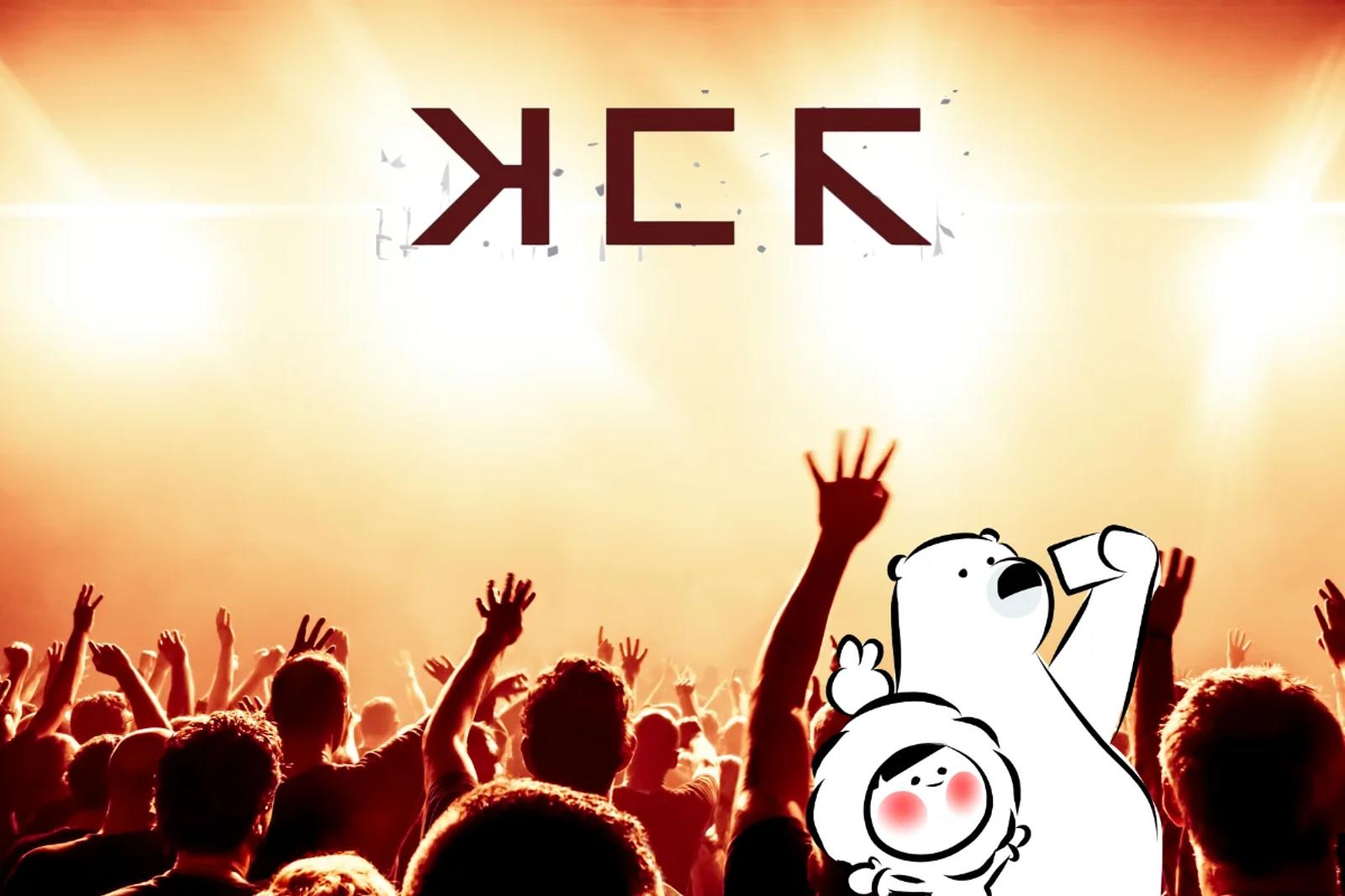 A large concert crowd with raised hands illuminated by warm stage lights, with bold “MCR” lettering glowing above the audience, creating an energetic live music atmosphere.