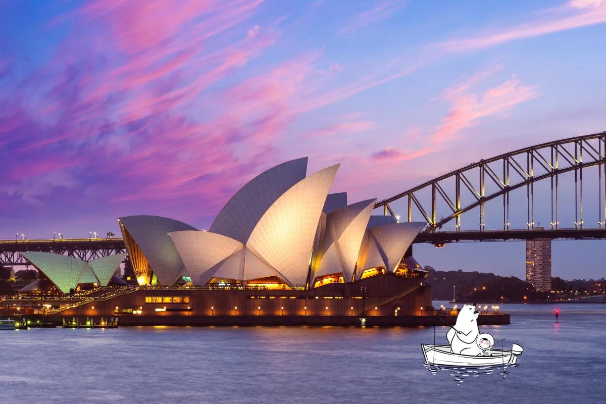 Sydney Opera House at sunset with vibrant pink and purple skies, the Harbour Bridge in the background.