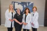 Four members of the Audiology & Hearing Services of Charlotte team in their office
