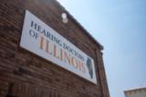 The Hearing Doctors of Illinois sign on the brick wall of the Macomb office