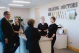 The Hearing Doctors of Iowa team talking at the front desk