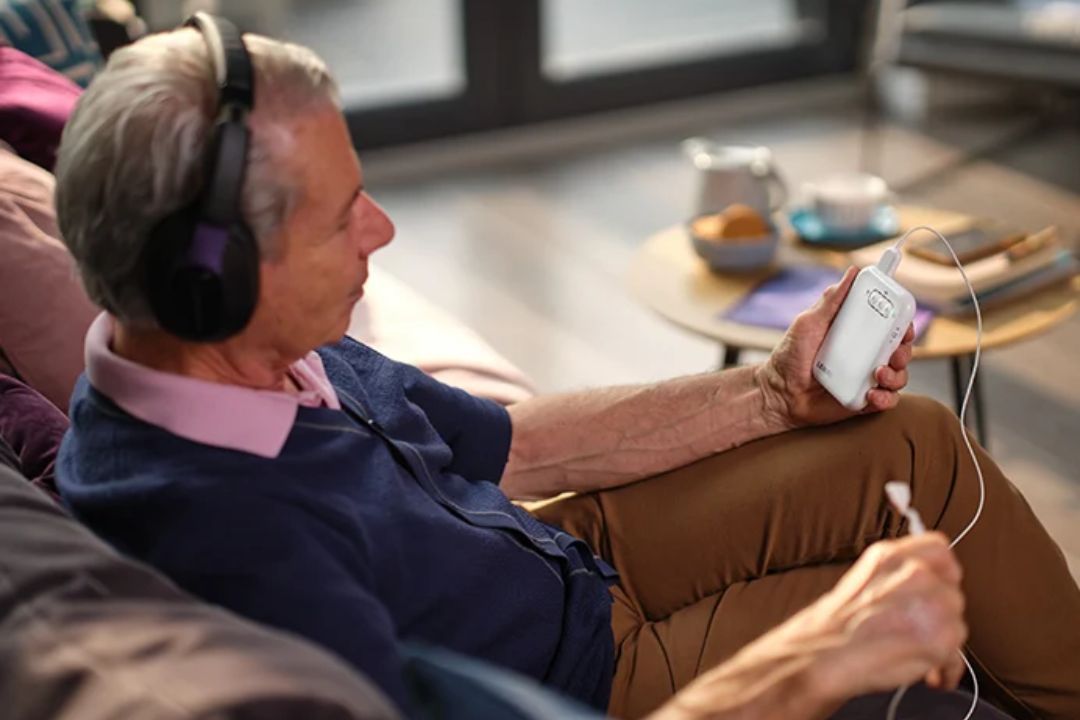 The Lenire device with headphones and a handheld controller