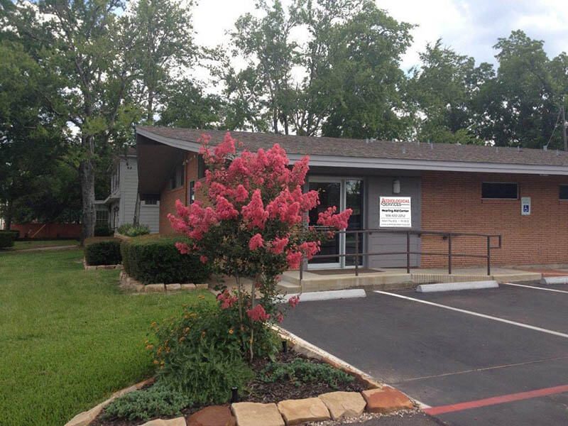 The Audiological Services office in Lufkin with a flowering tree out front