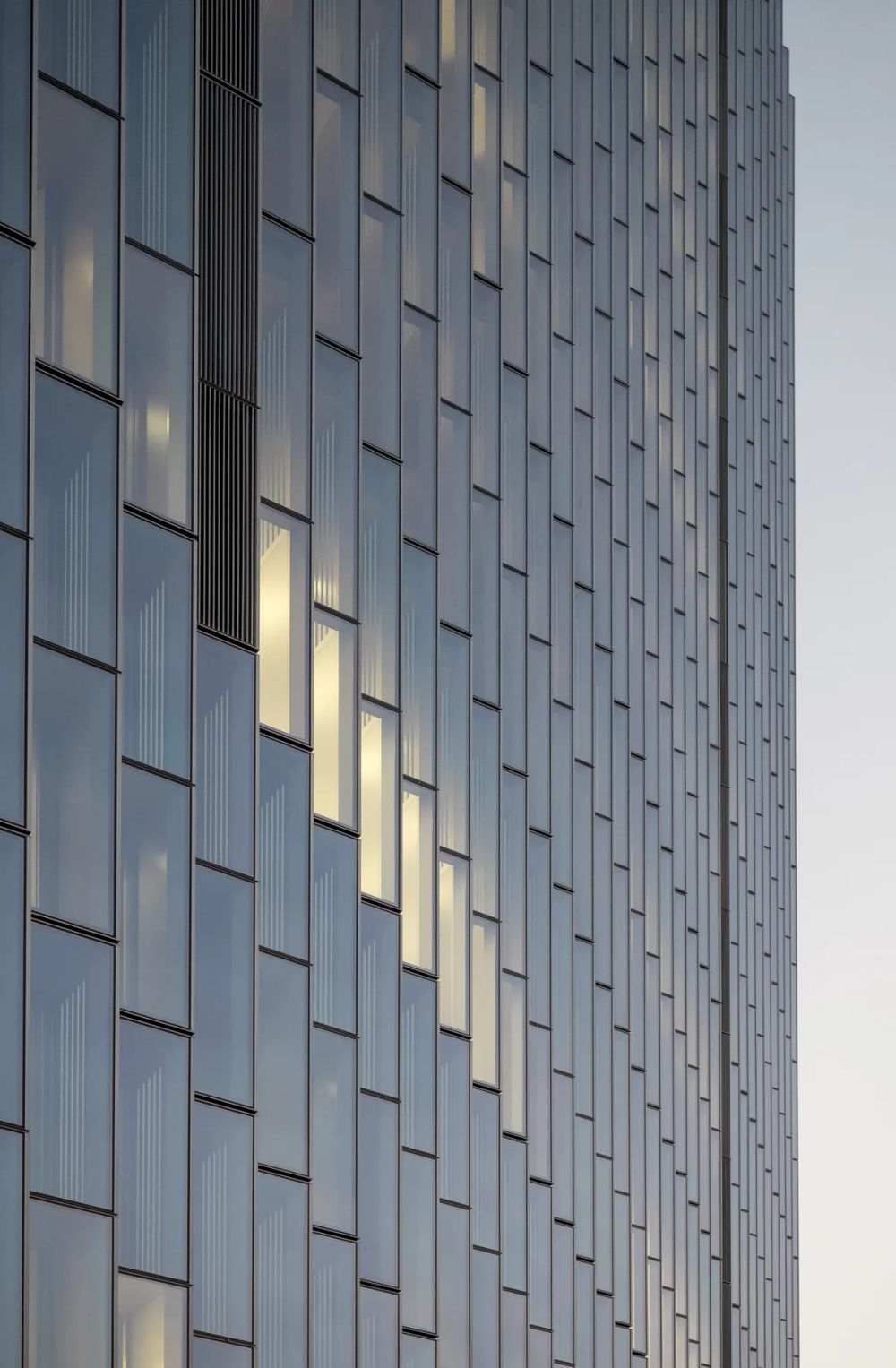 Soft sunlight catching staggered silver facade panels