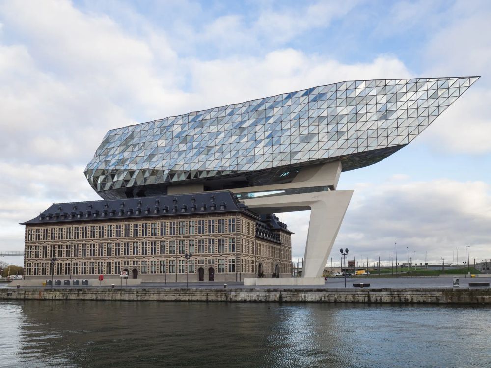 A faceted glass volume above a historic waterfront building