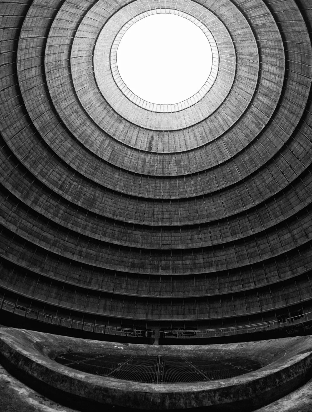 Concentric concrete rings surrounding a bright circular skylight
