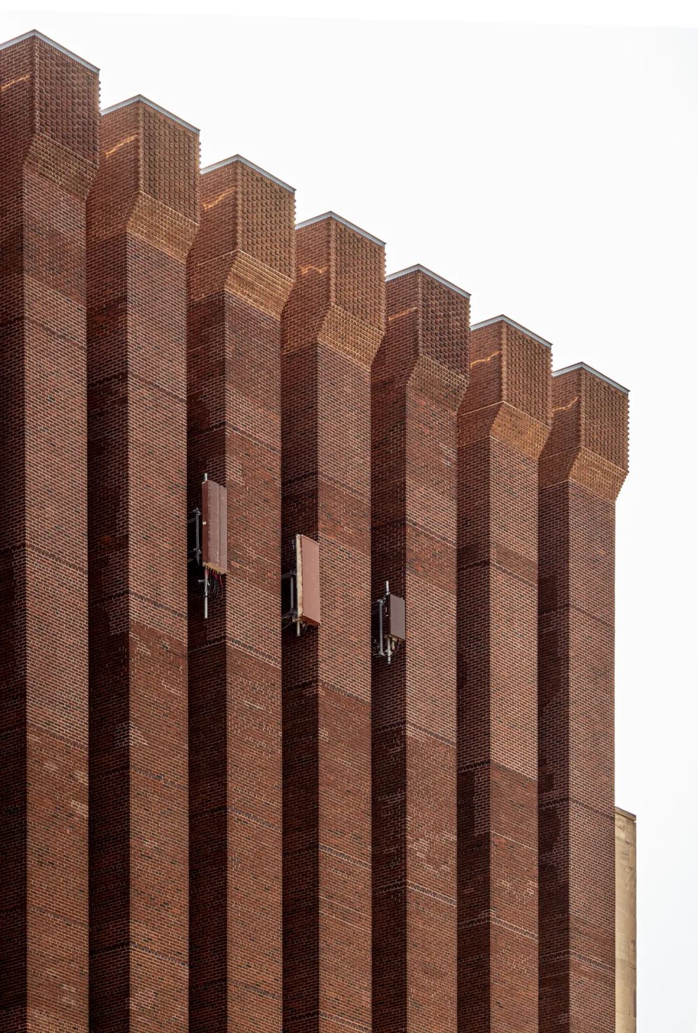 Repeated brick fins illuminated by angled sunlight