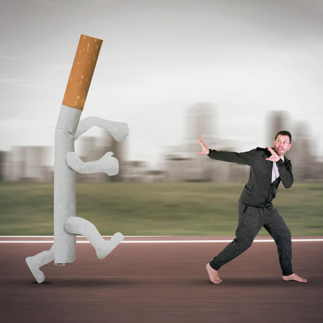 Man running away from a cartoon cigarette