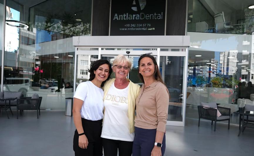 Three women posing in front of a clinic entrance