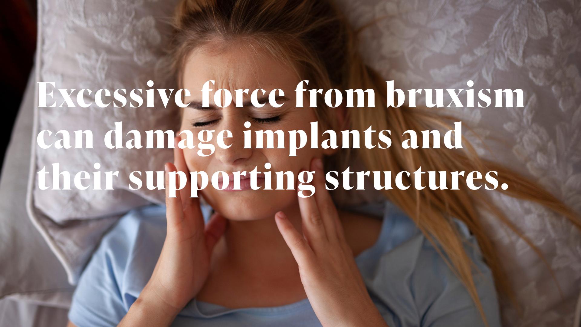 Woman lying in bed holding both sides of her jaw in discomfort