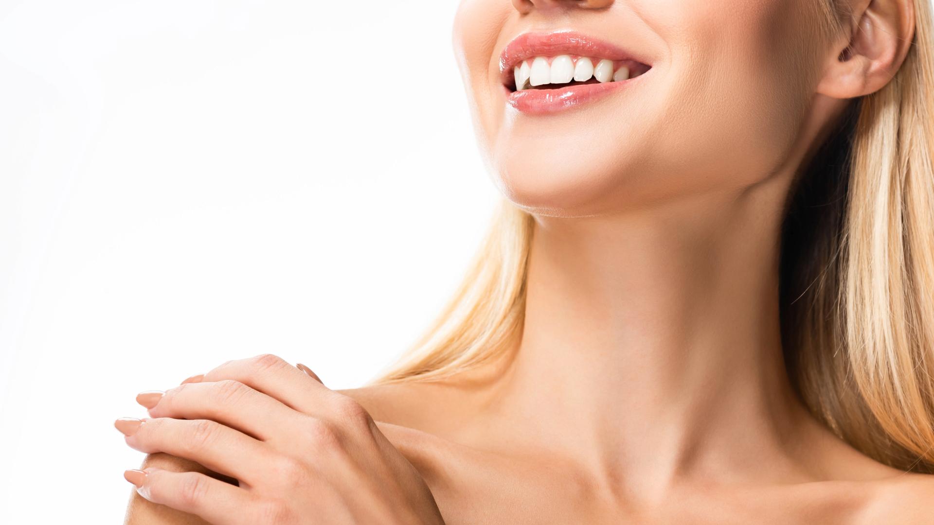 Lower face of a smiling woman with white teeth